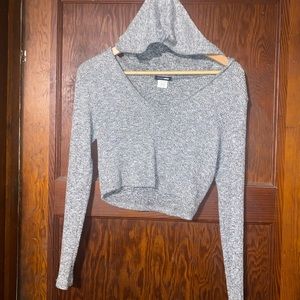 A long sleeve crop top with a hood